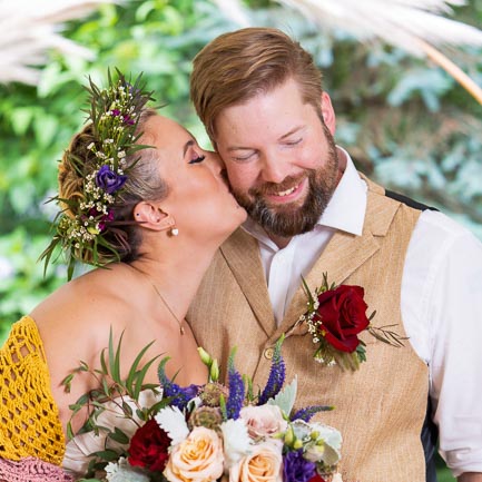 A wedding couple sharing a kiss.