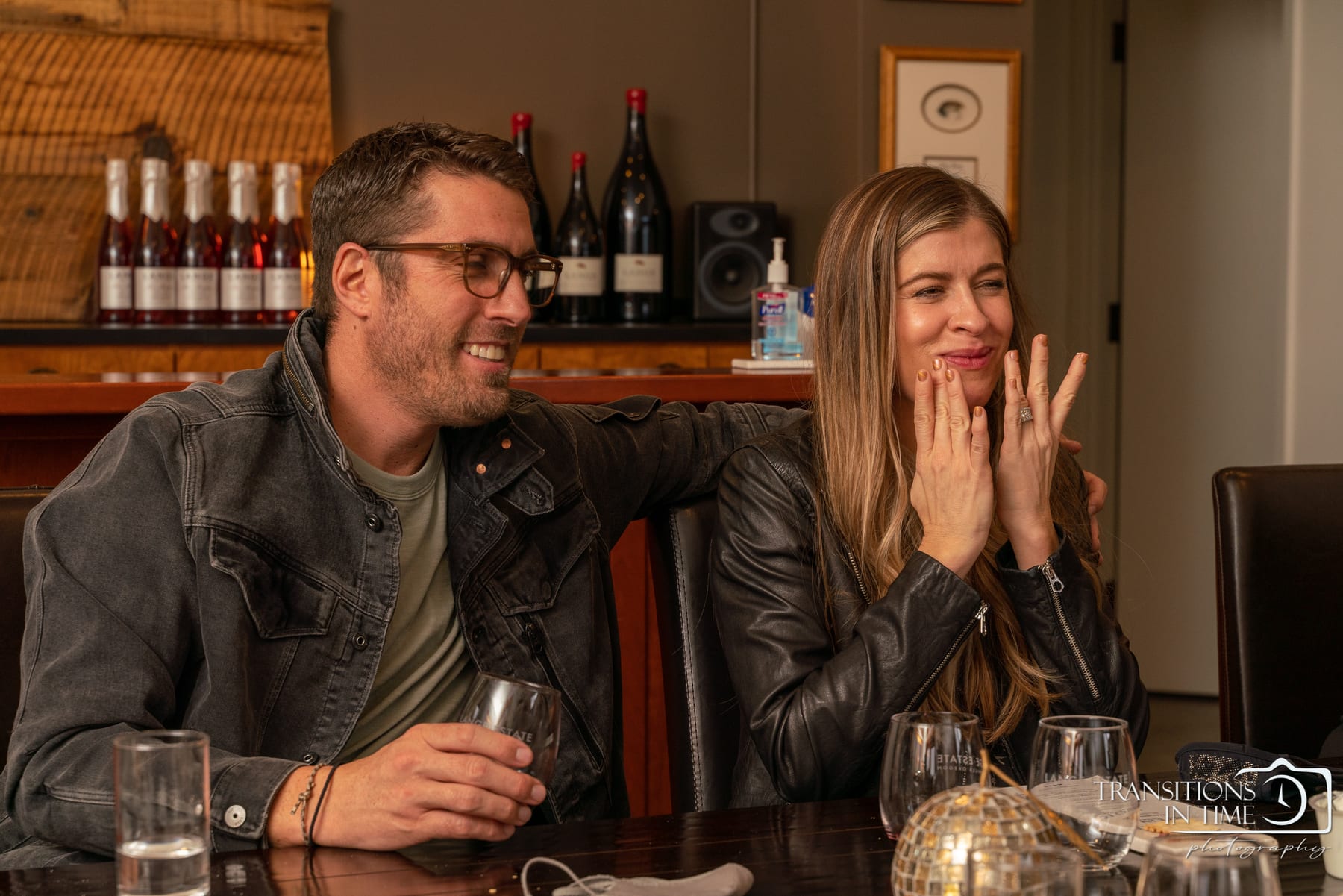 A couple shares a laugh over a wine tasting.