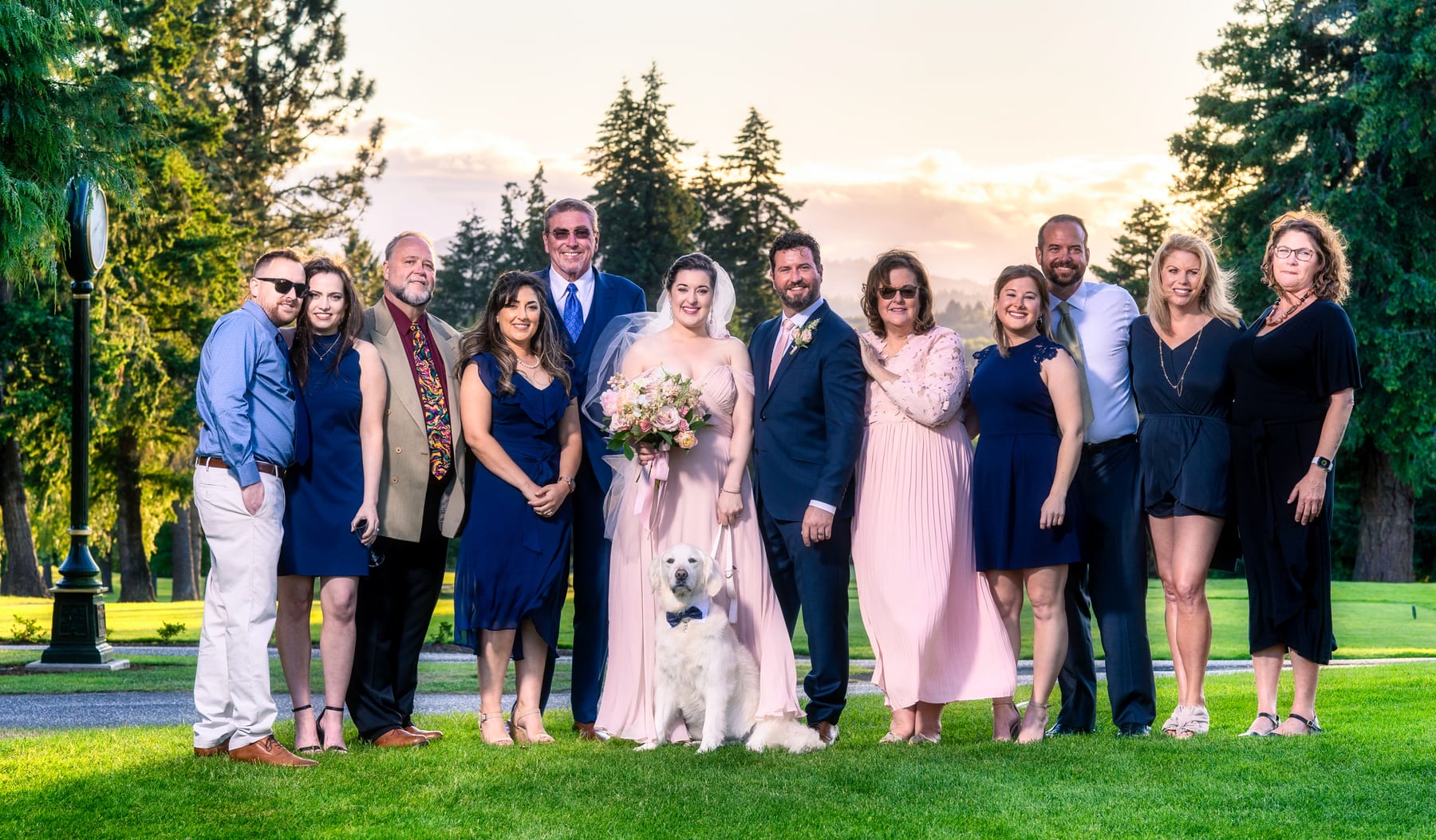 A family lines up together on a golf course at a wedding.