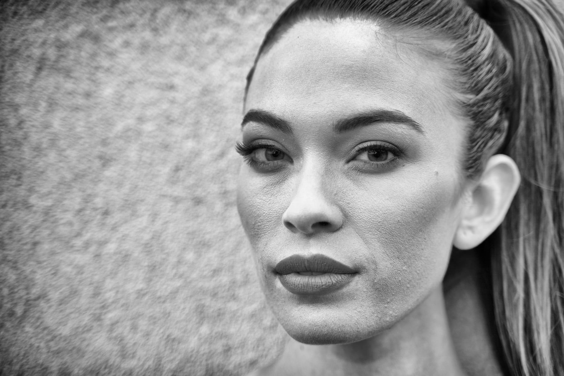 A close black and white portrait of a senior.