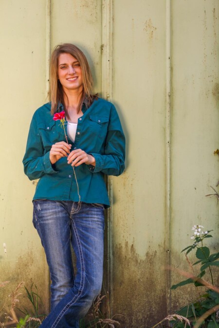 Senior portrait surrounded by flowers.