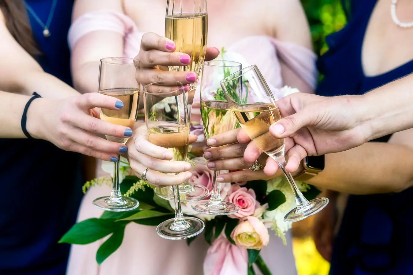 A bride and groom surrounded by their family.