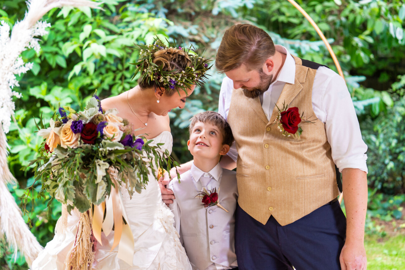 Newlyweds sharing a family moment on their wedding day.