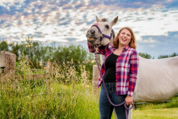 A senior having fun taking photos with her horse in Corvallis, Oregon.
