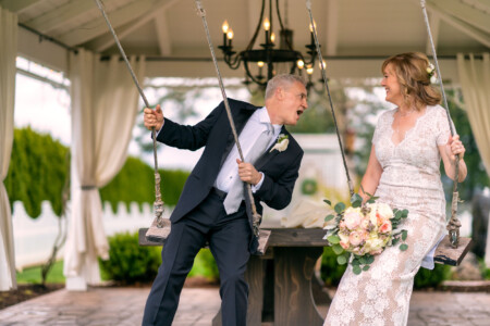 A wedding couple sharing a private moment on a swing.